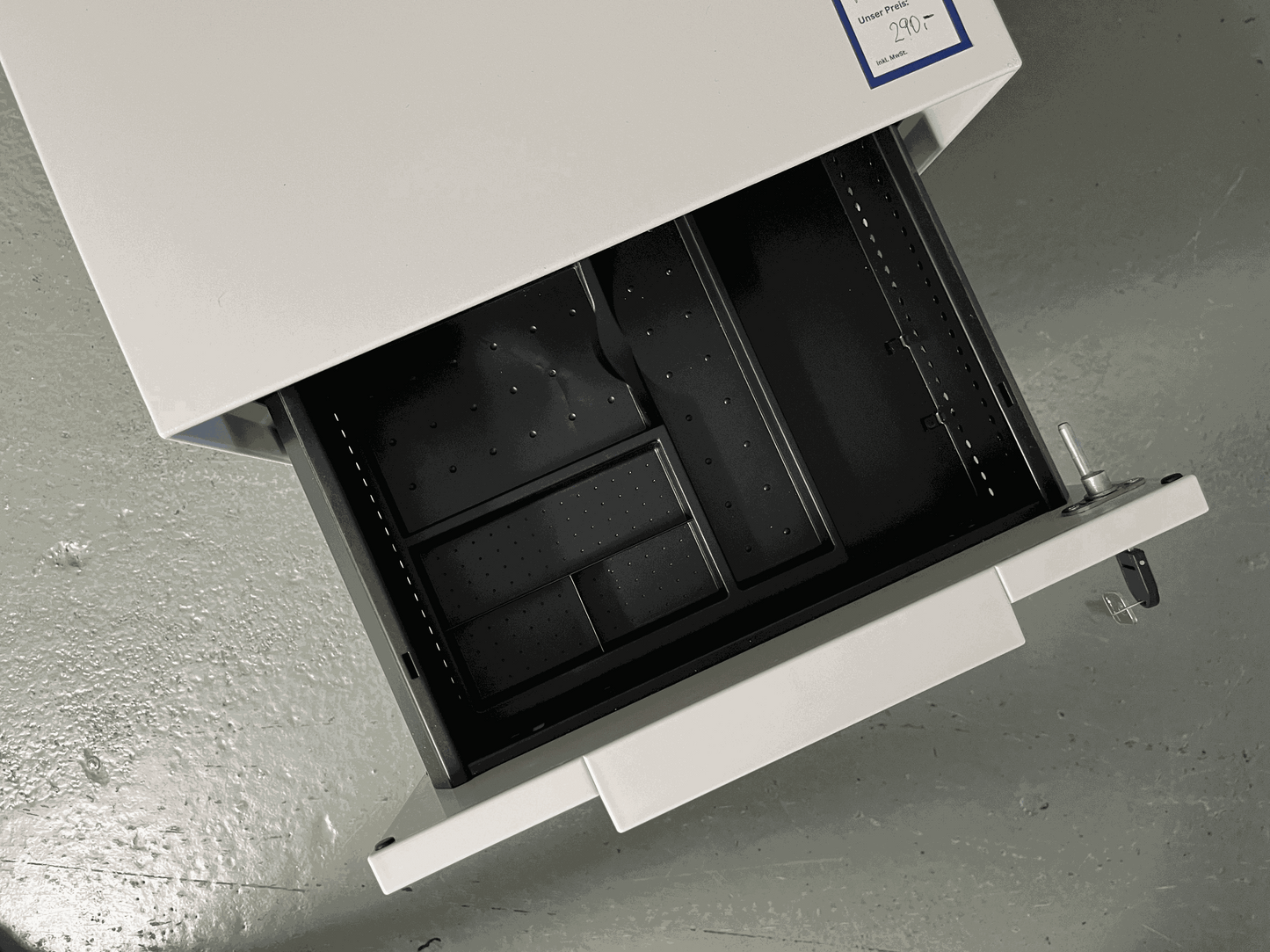 Vitra Rollcontainer white metal body with plastic fronts open drawer showing black interior organizer.