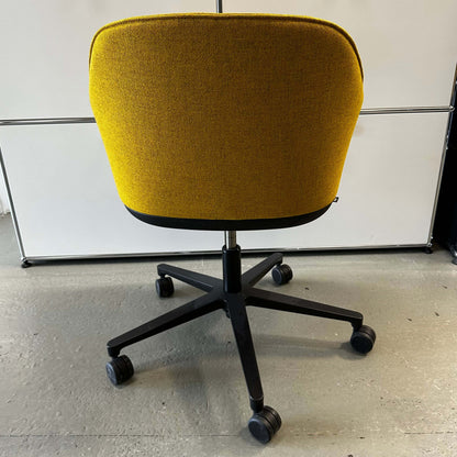 Yellow Vitra Softshell office swivel chair with five-star black base and caster wheels viewed from the back