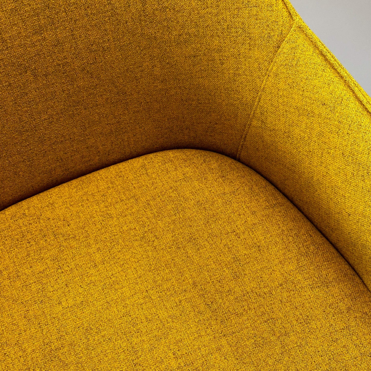 Close-up of yellow Vitra Softshell Drehstuhl chair seat and backrest fabric texture
