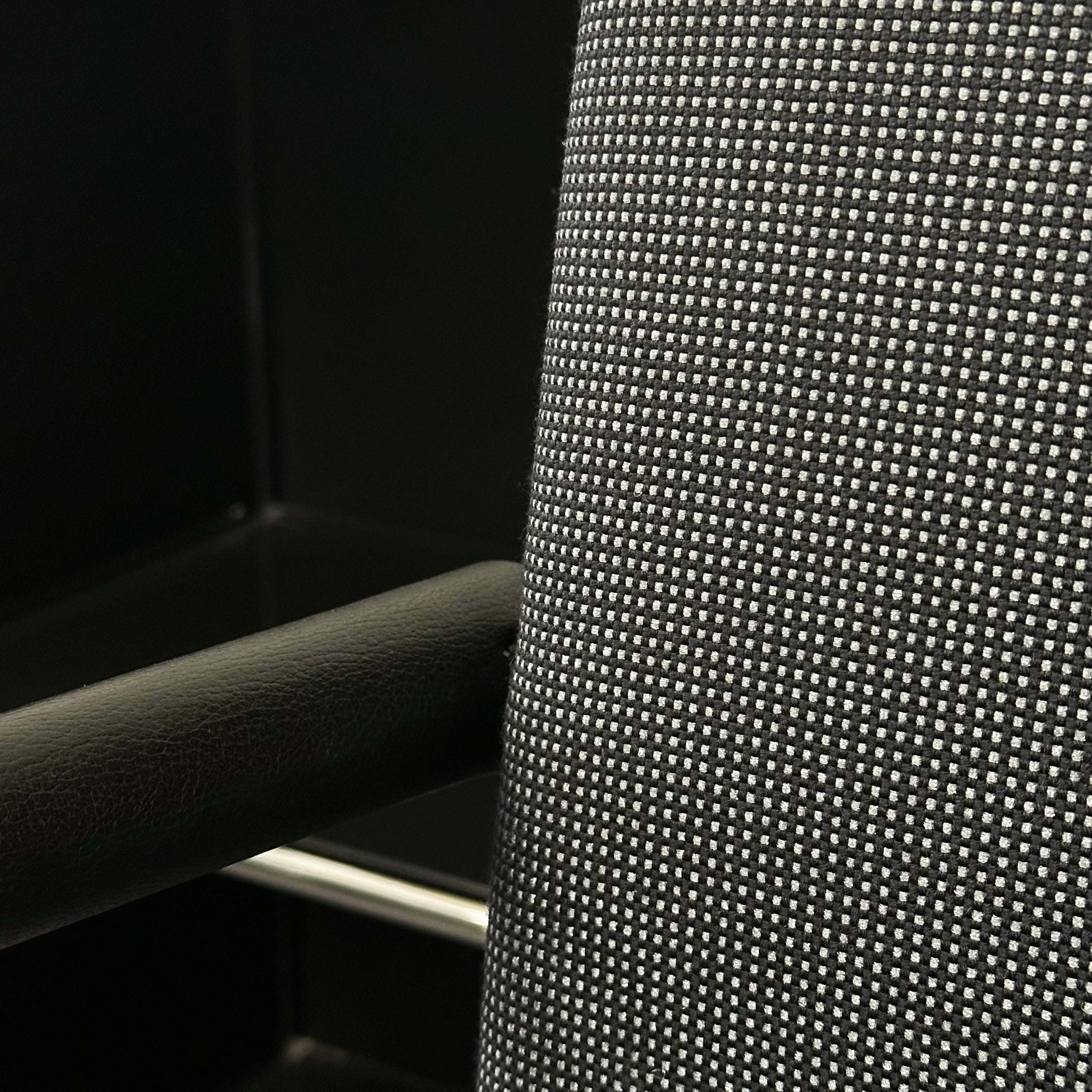 Close-up of black and grey textured fabric and armrest detail on Vitra Visasoft visitor chair
