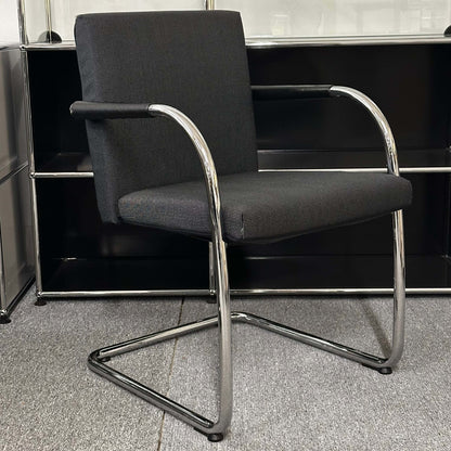 Vitra Visasoft black and gray fabric visitor chair with chrome cantilever frame and armrests in office setting