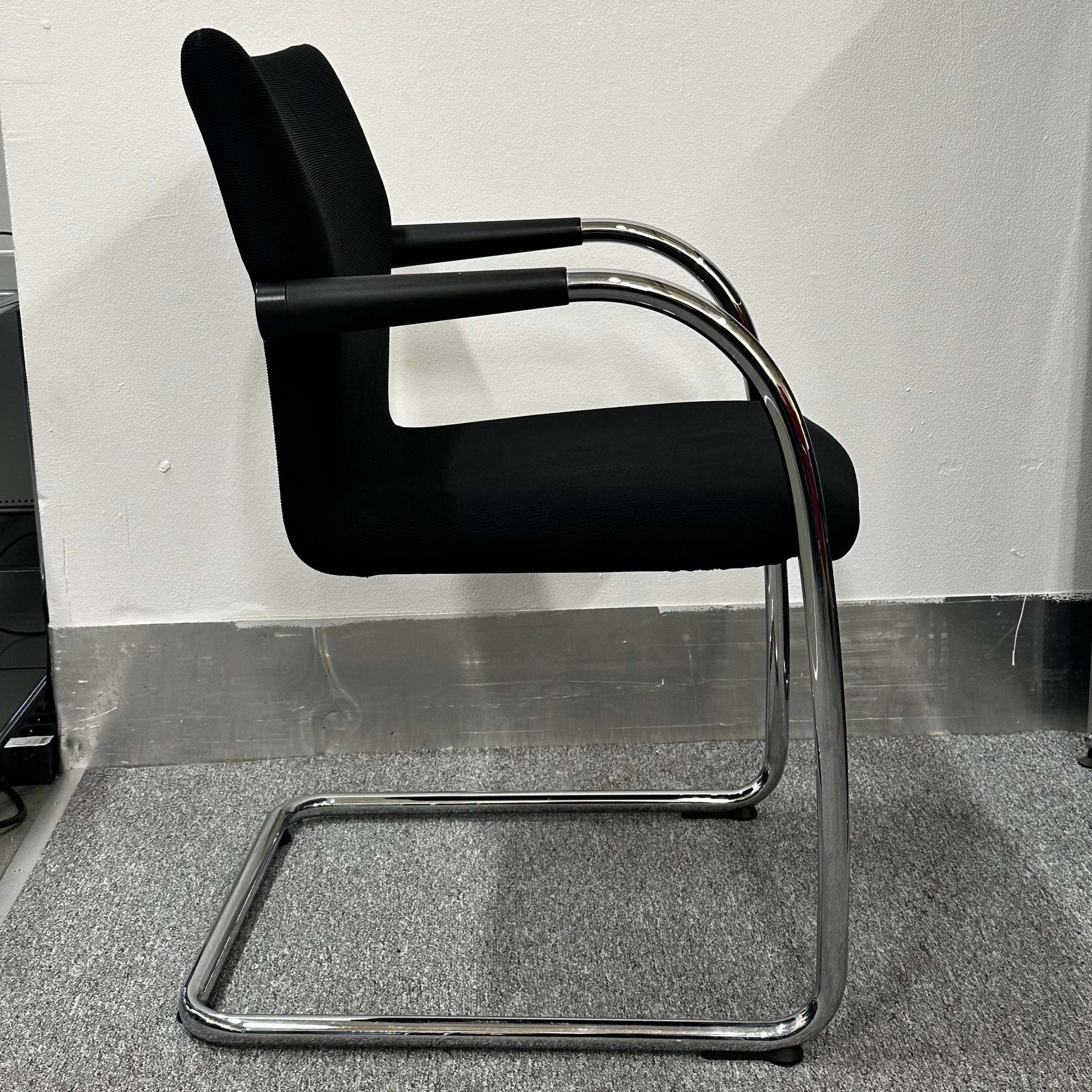 Black Vitra Visastripe conference chair with chrome cantilever frame and ergonomic design