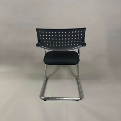 Vitra Visavis 1 black stackable chair with chrome frame and perforated backrest