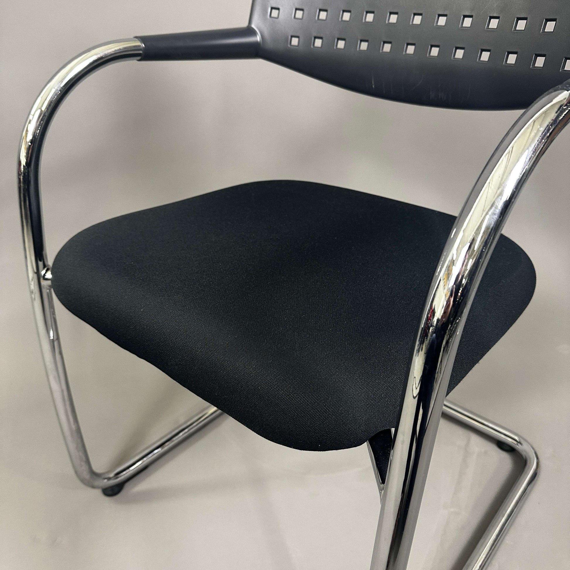 Vitra Visavis 1 black stacking chair with chrome frame and padded seat