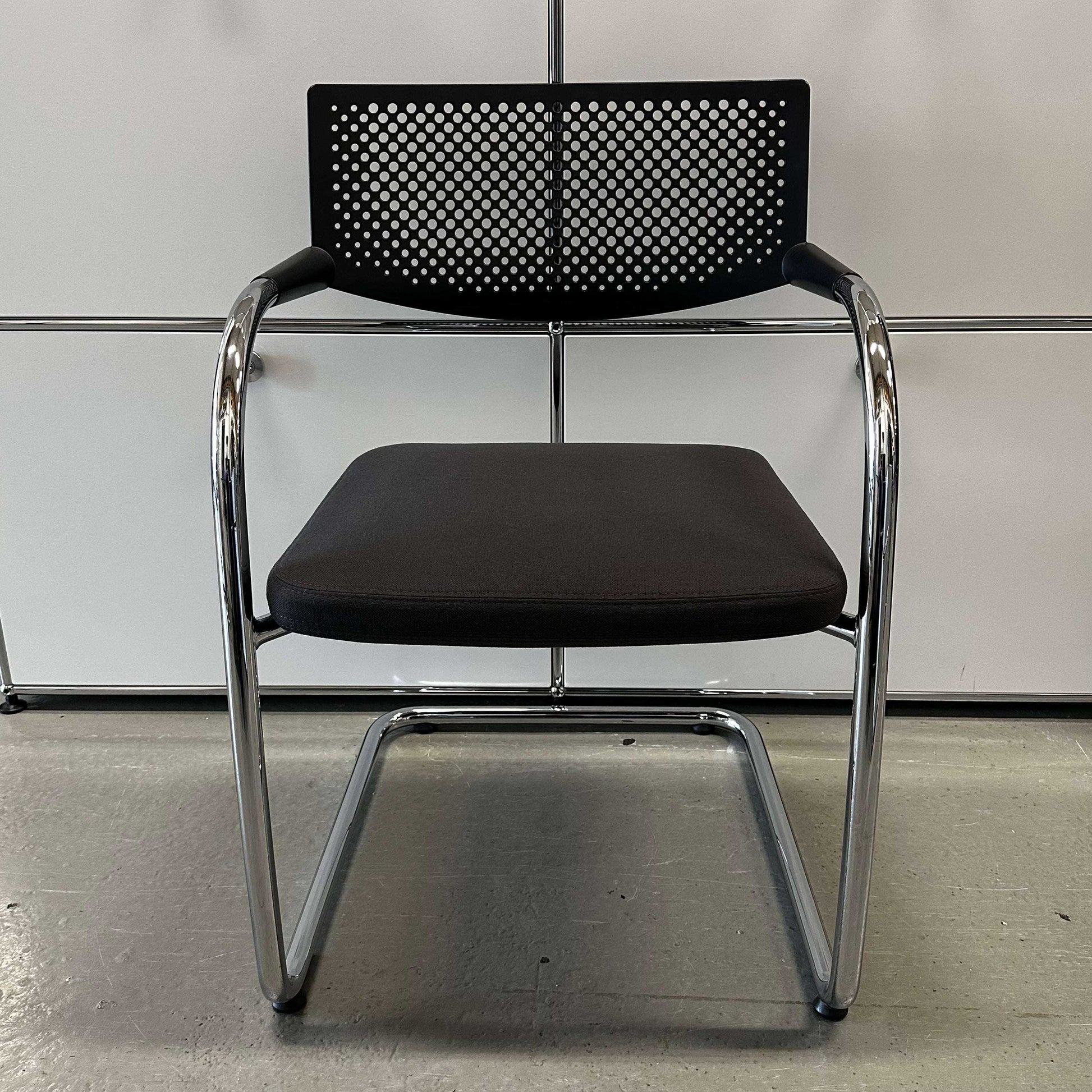 Vitra Visavis 2 chair with dark grey fabric seat, black perforated plastic backrest, and chrome cantilever frame