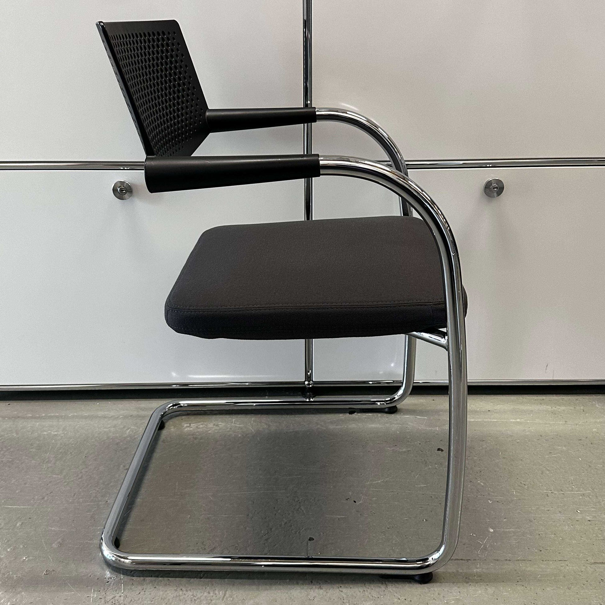 Vitra Visavis 2 chair with dark grey fabric seat, black plastic backrest, and chrome frame