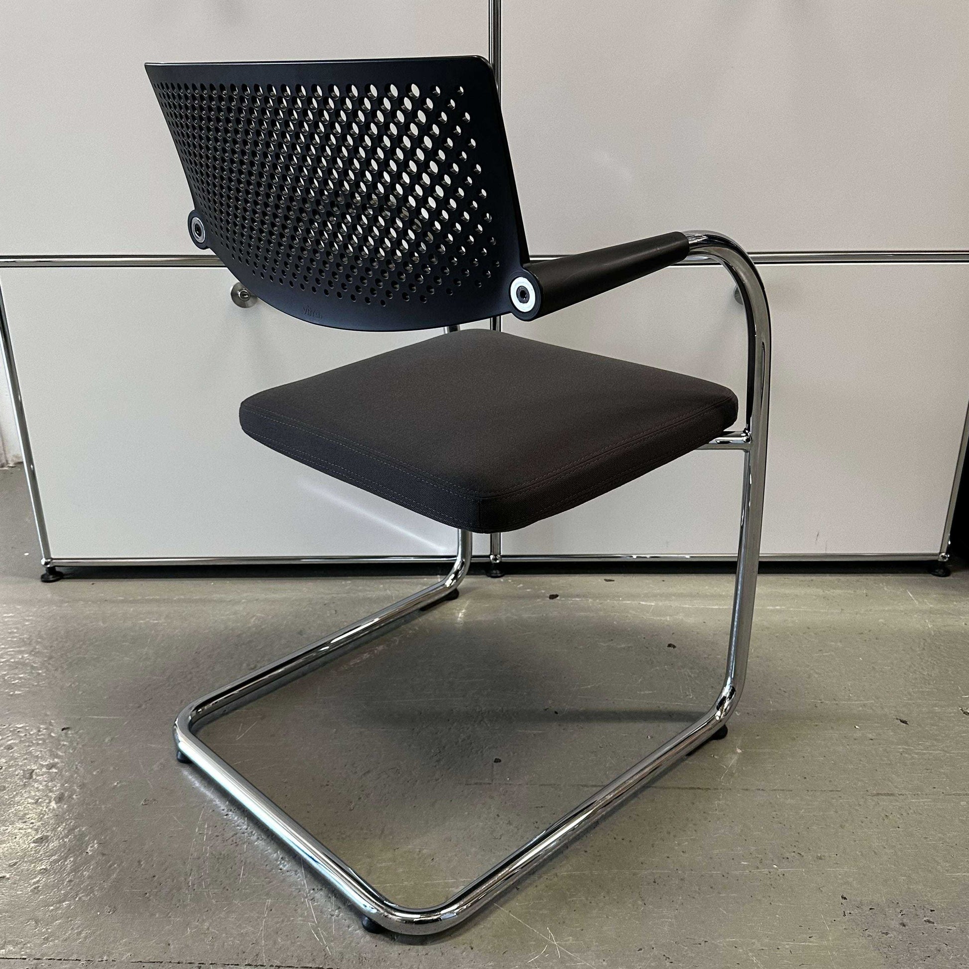 Vitra Visavis 2 chair with dark grey fabric seat, black plastic backrest, and chrome frame