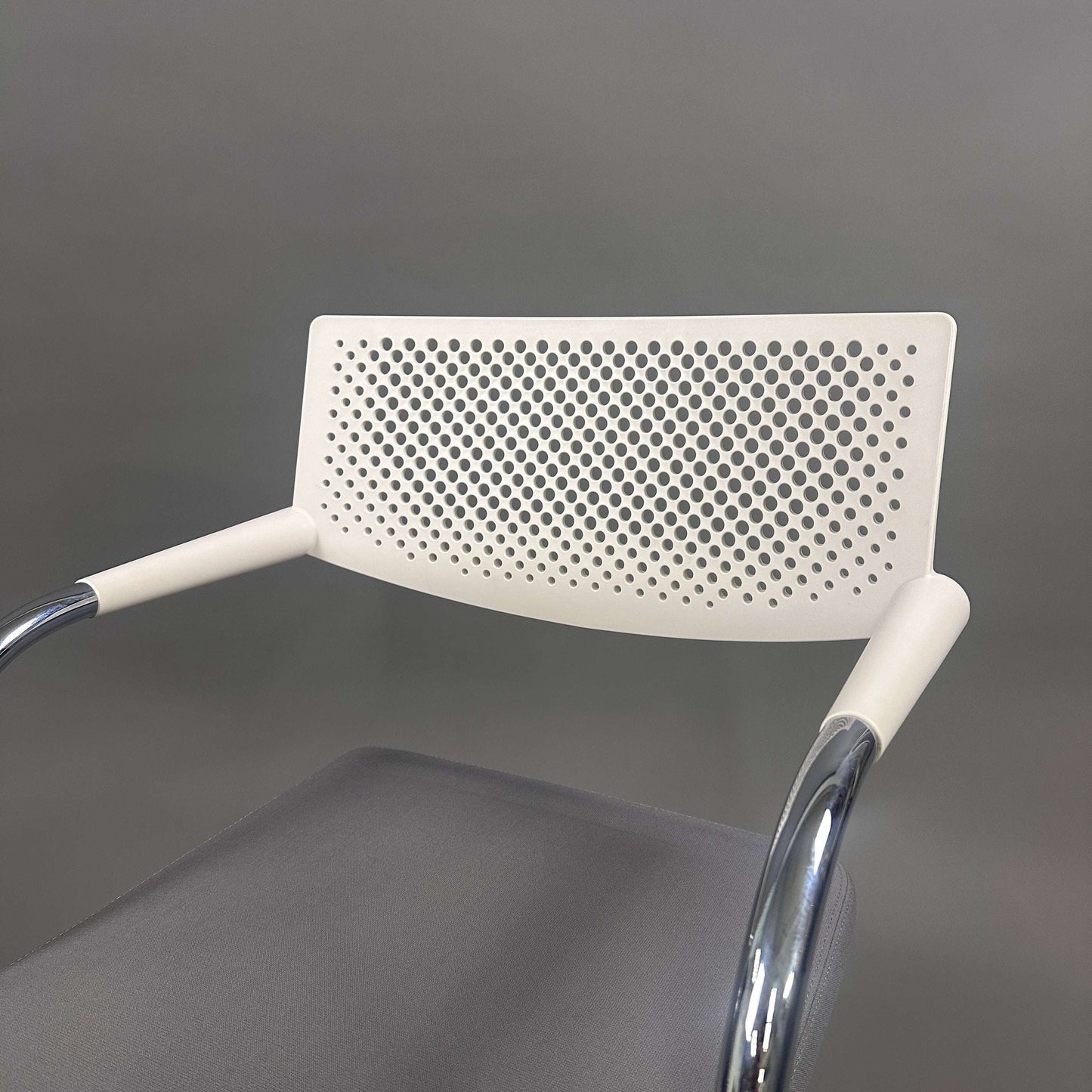 Vitra Visavis 2 chair with gray upholstered seat, white perforated plastic backrest, and chrome frame