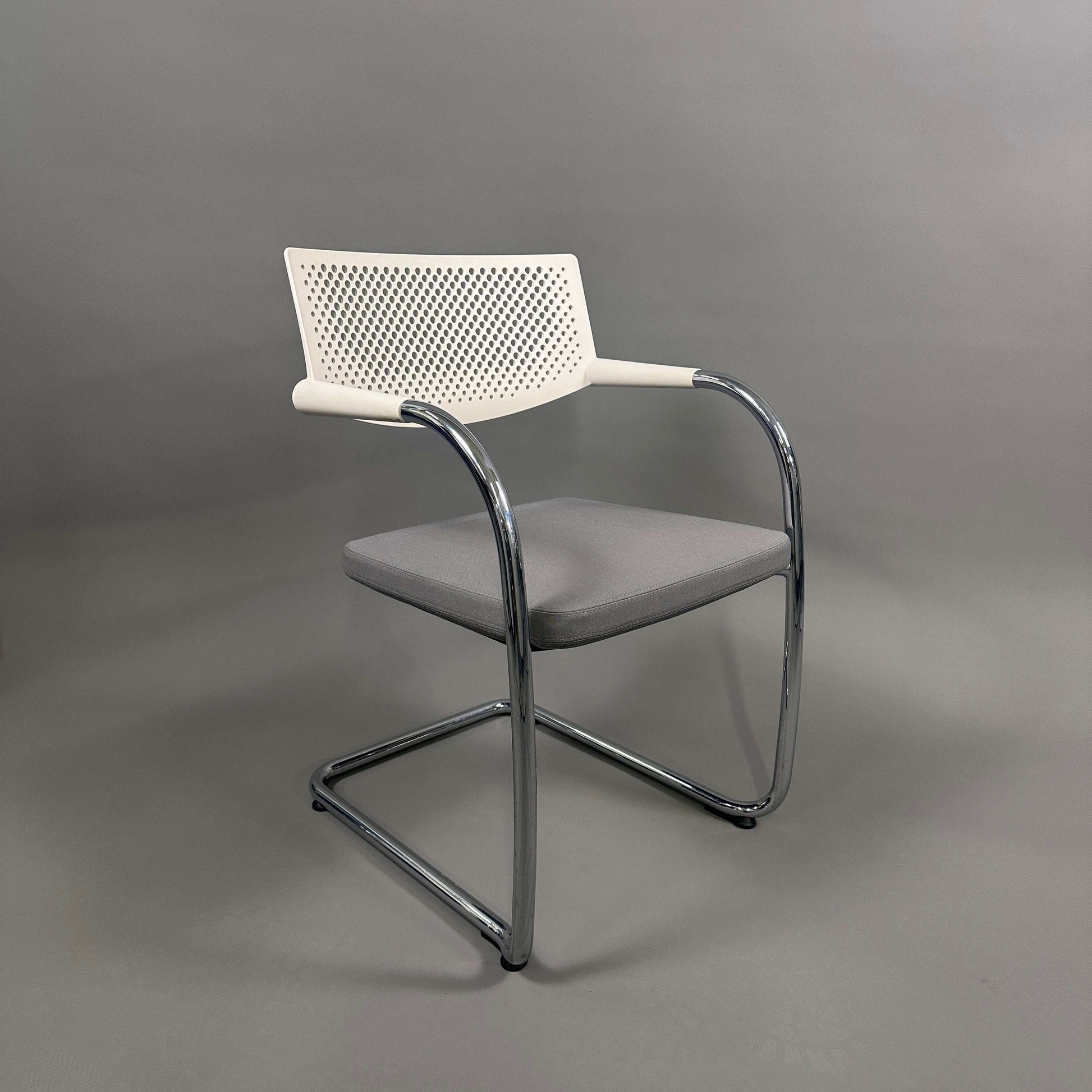 Vitra Visavis 2 chair with grey upholstered seat, white plastic backrest, and chrome frame, stackable design