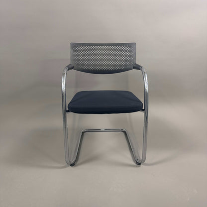 Vitra Visavis 2 black visitor chair with black fabric seat, perforated black plastic backrest, and chrome frame
