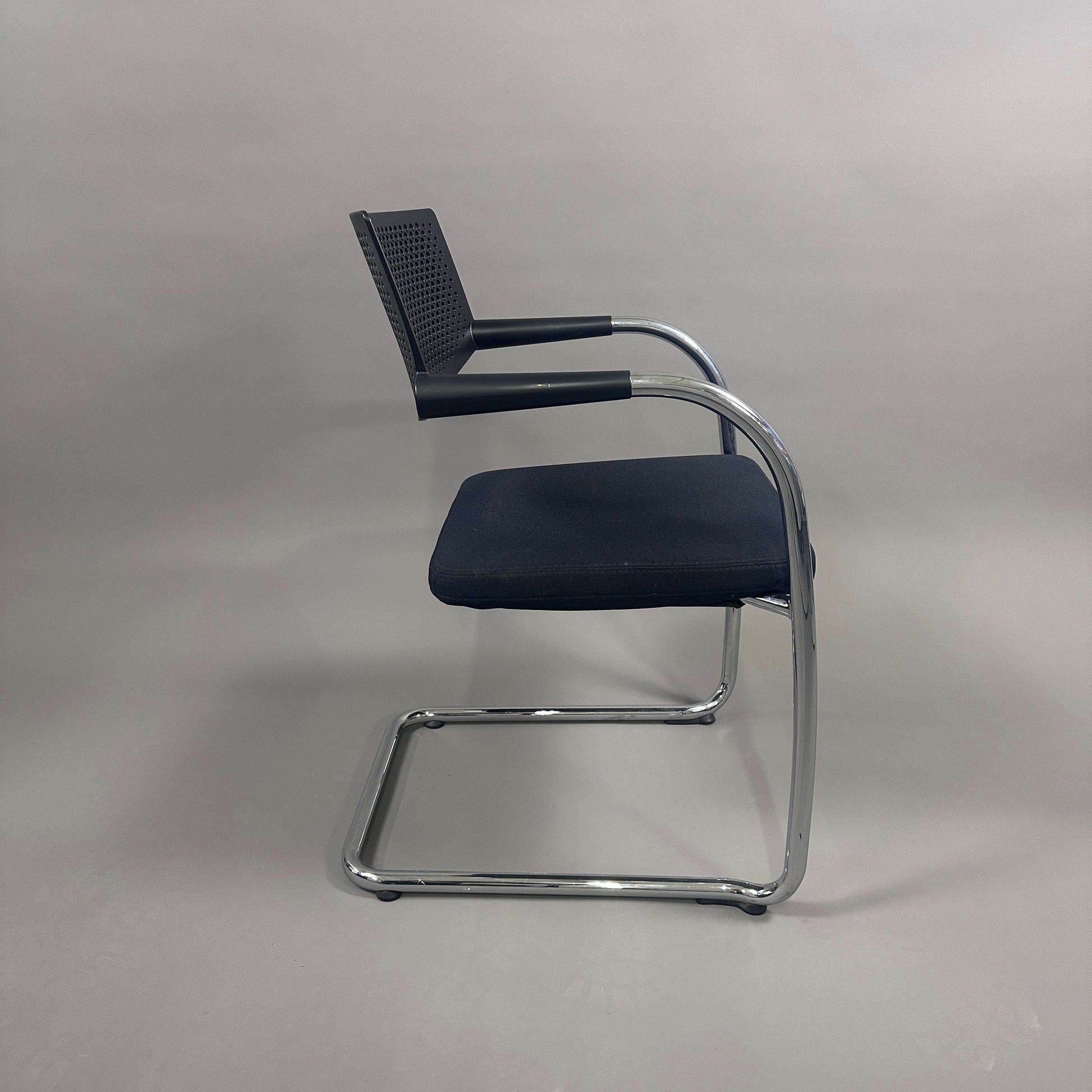 Side view of Vitra Visavis 2 black visitor chair with fabric seat and chrome frame
