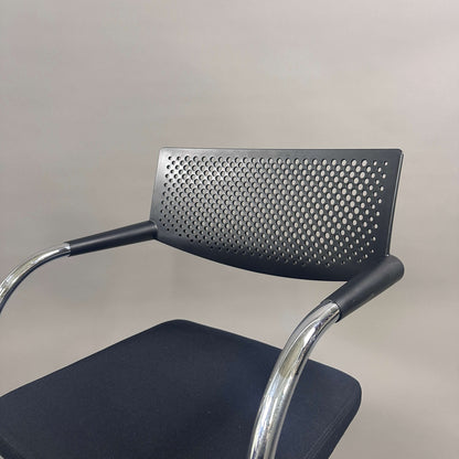 Vitra Visavis 2 black visitor chair with perforated backrest, black fabric seat, and chrome frame