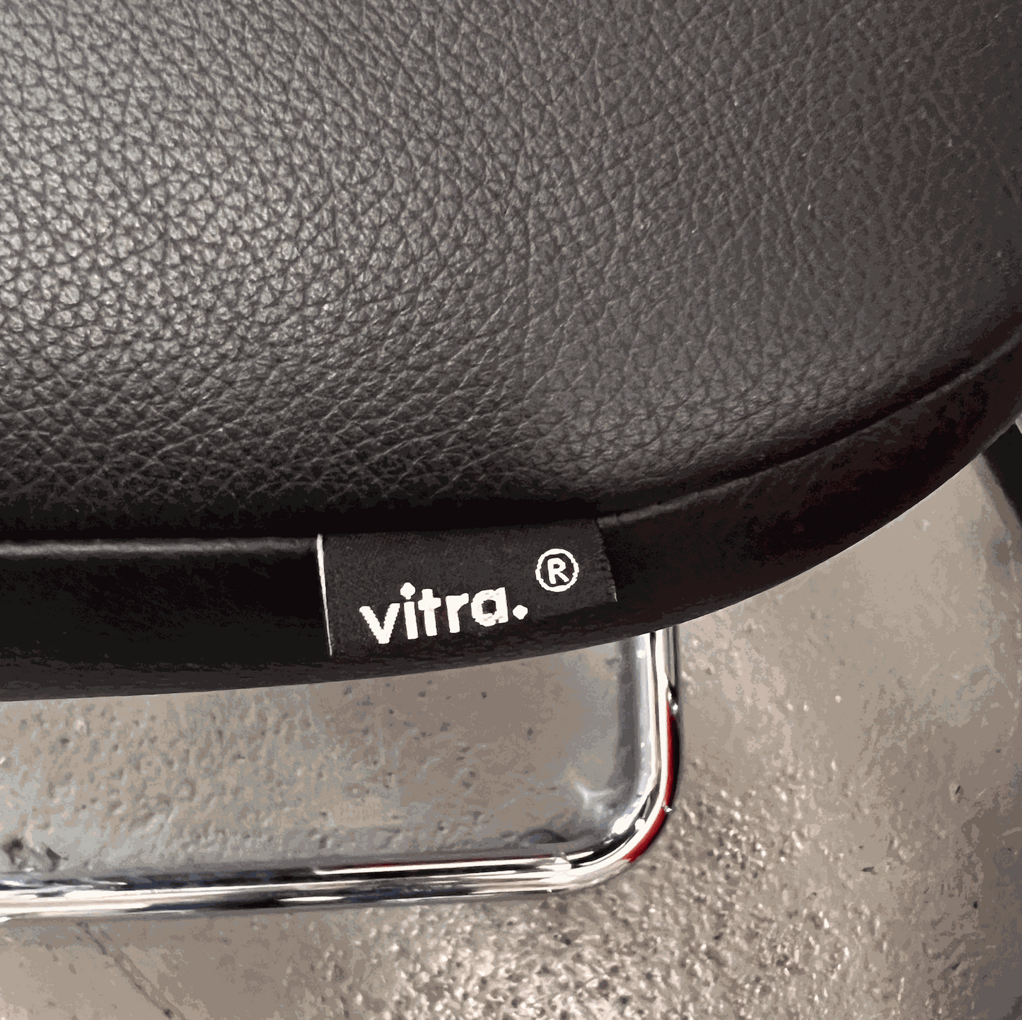 Vitra Visavis black softback leather chair with chrome frame close-up detail