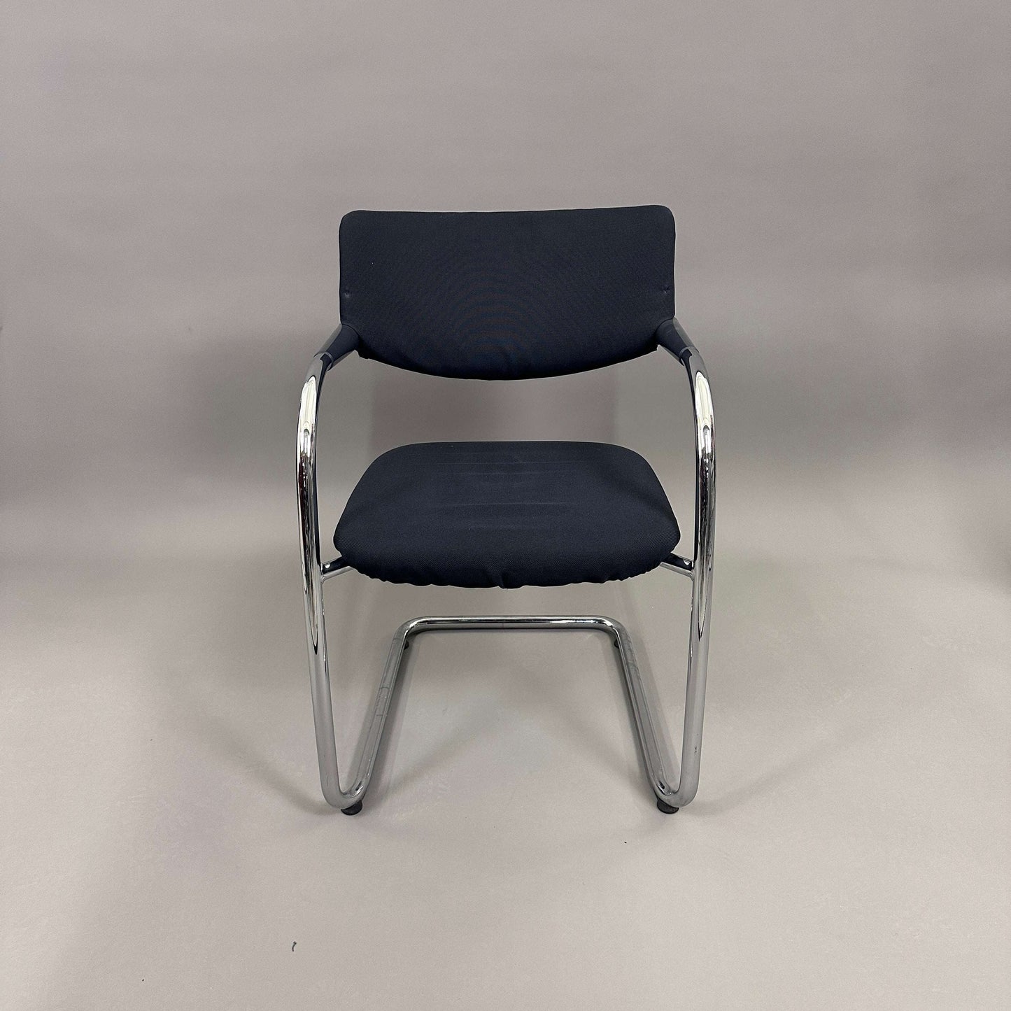 Vitra Visavis Softback black fabric chair with chrome frame and plastic armrests, front view