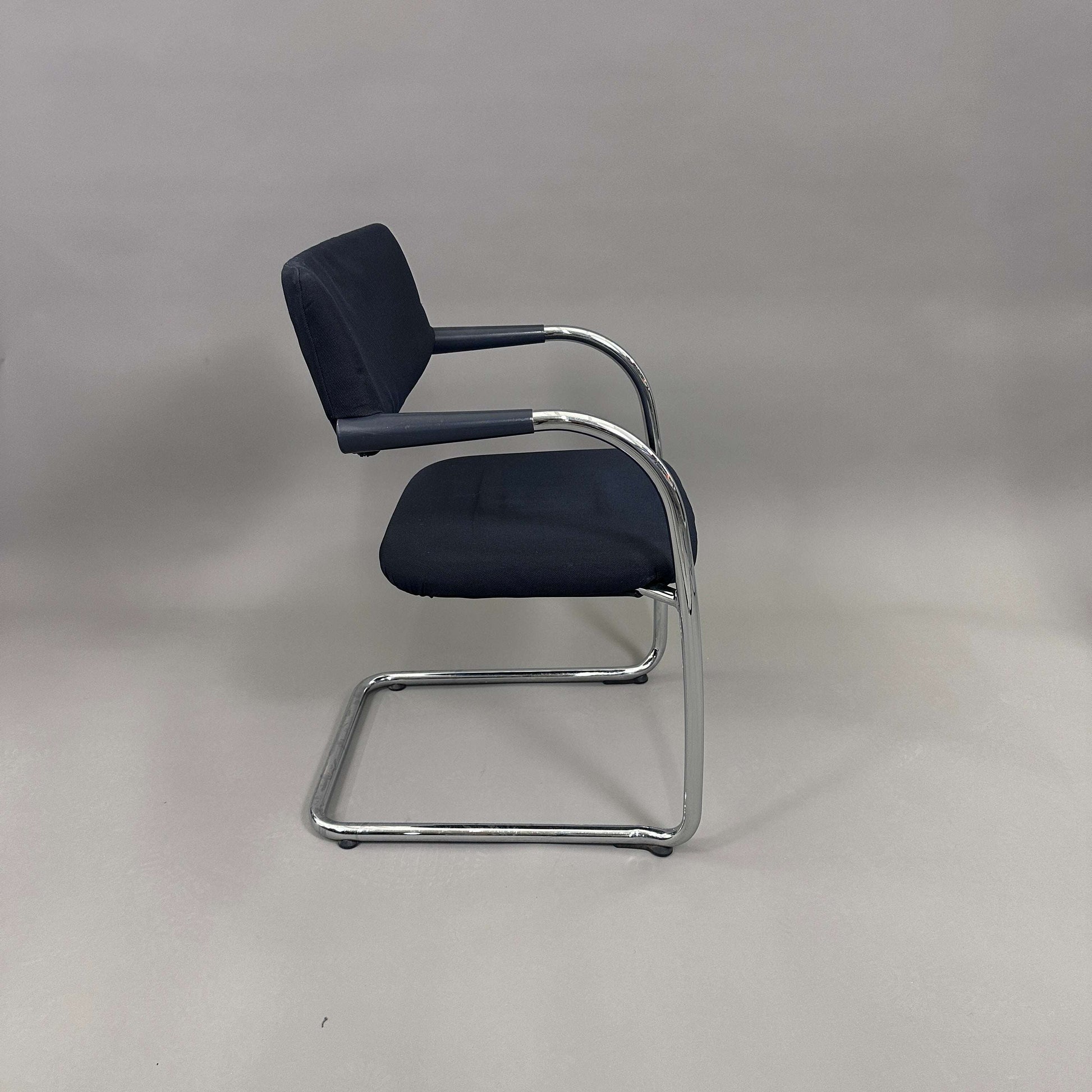 Vitra Visavis Softback chair with black fabric upholstery, chrome frame, padded backrest, and plastic armrests