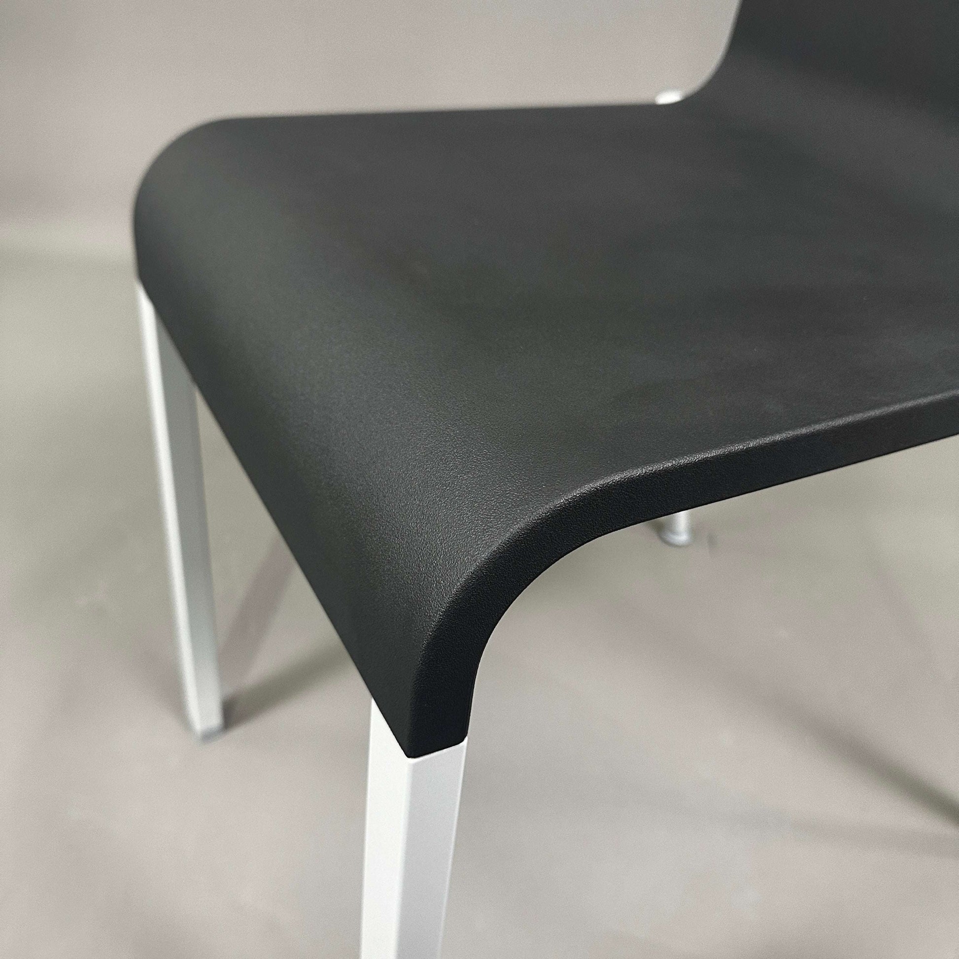 Close-up of black seat and silver matte aluminum frame of Vitra .03 Besucherstuhl visitor chair