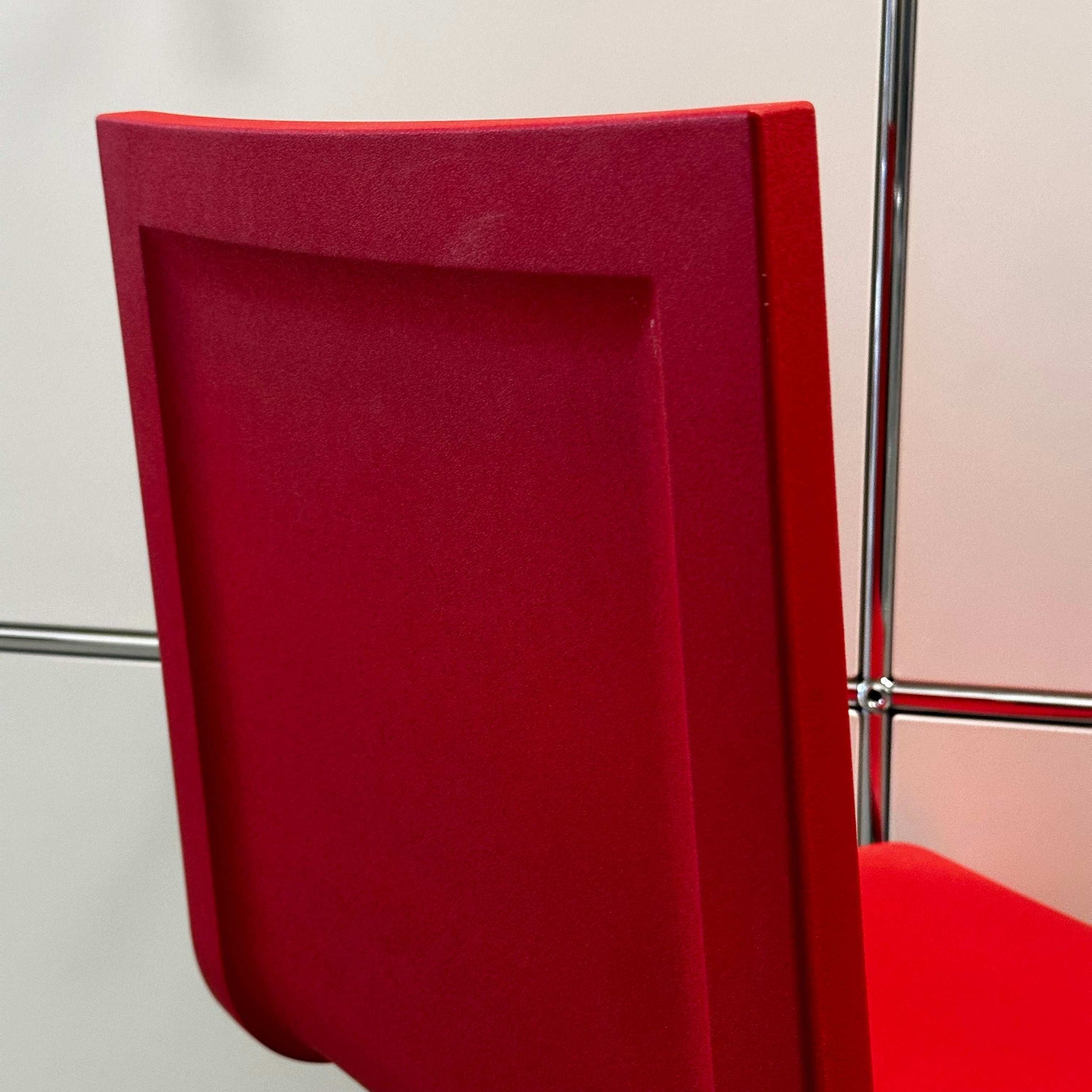 Red Vitra .05 Maarten van Severen chair with stainless steel frame and flexible polyurethane seat shell