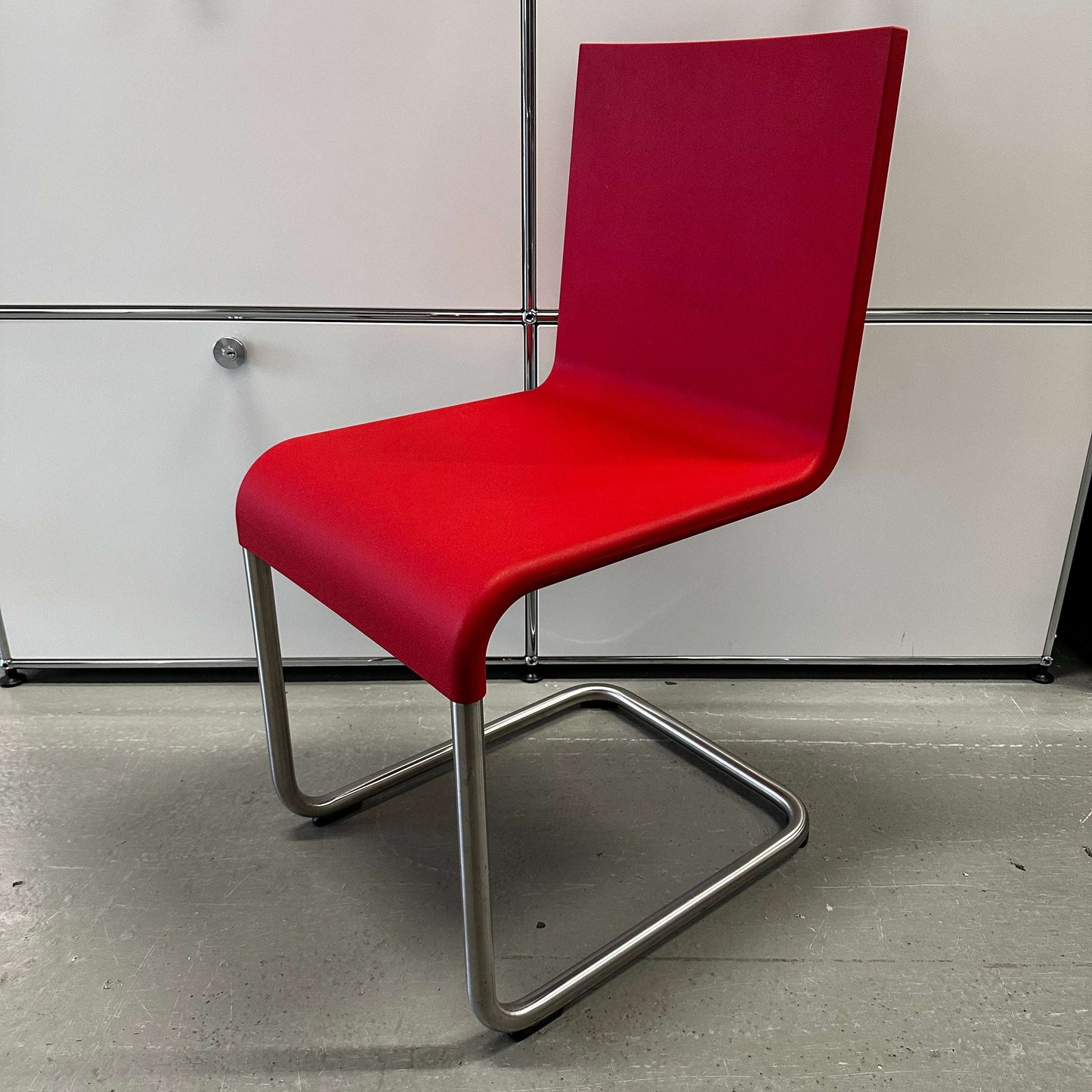 Vitra .05 Maarten van Severen chair in signal red with stainless steel frame and polyurethane seat shell