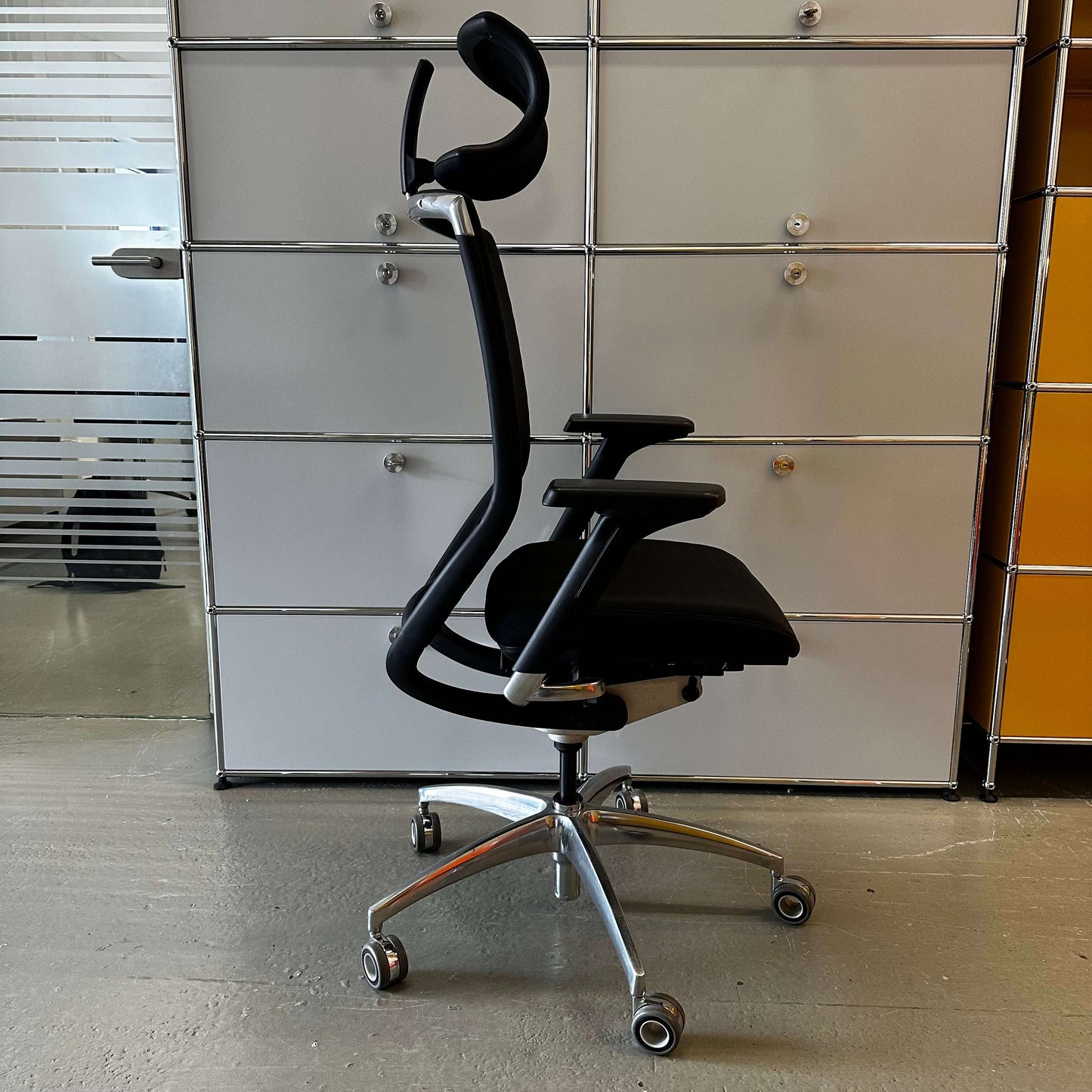 Ergonomic black Wagner Titan 20 office chair with headrest and adjustable armrests on caster wheels