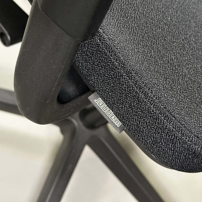 Close-up of black Wagner W1 office chair seat and mesh back with adjustable ergonomic features