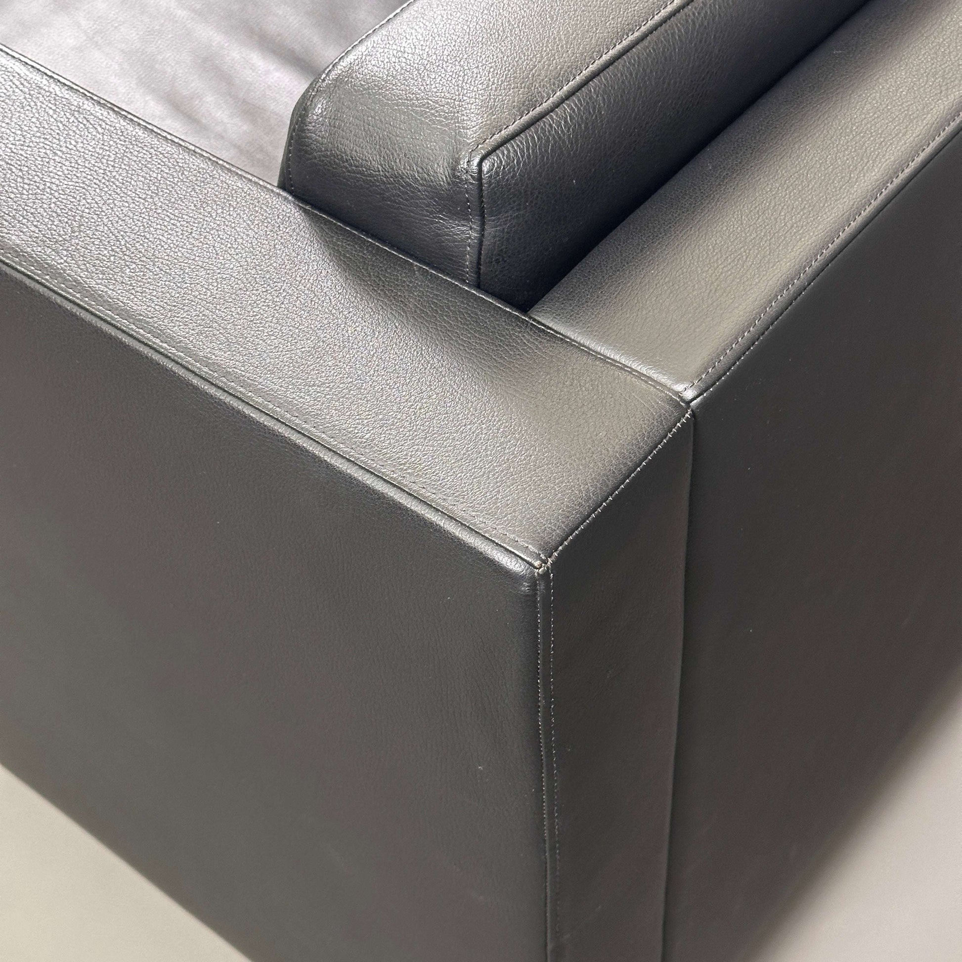 Close-up of black Walter Knoll Foster 500 leather chair with chrome-plated spring steel frame showing high-quality cowhide upholstery