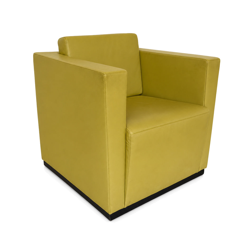 Moderner Walter Knoll Ledersessel in Gelb-Grün mit kubischem Design und schwarzem Sockel auf weißem Hintergrund.