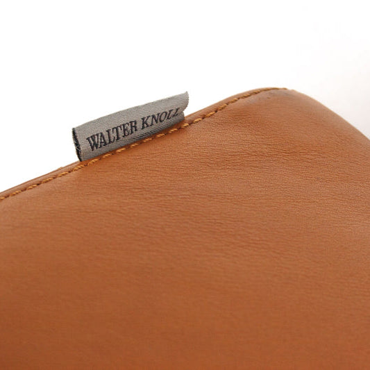 Close-up of Walter Knoll Living Landscape 730 sofa in cognac leather with brand tag.
