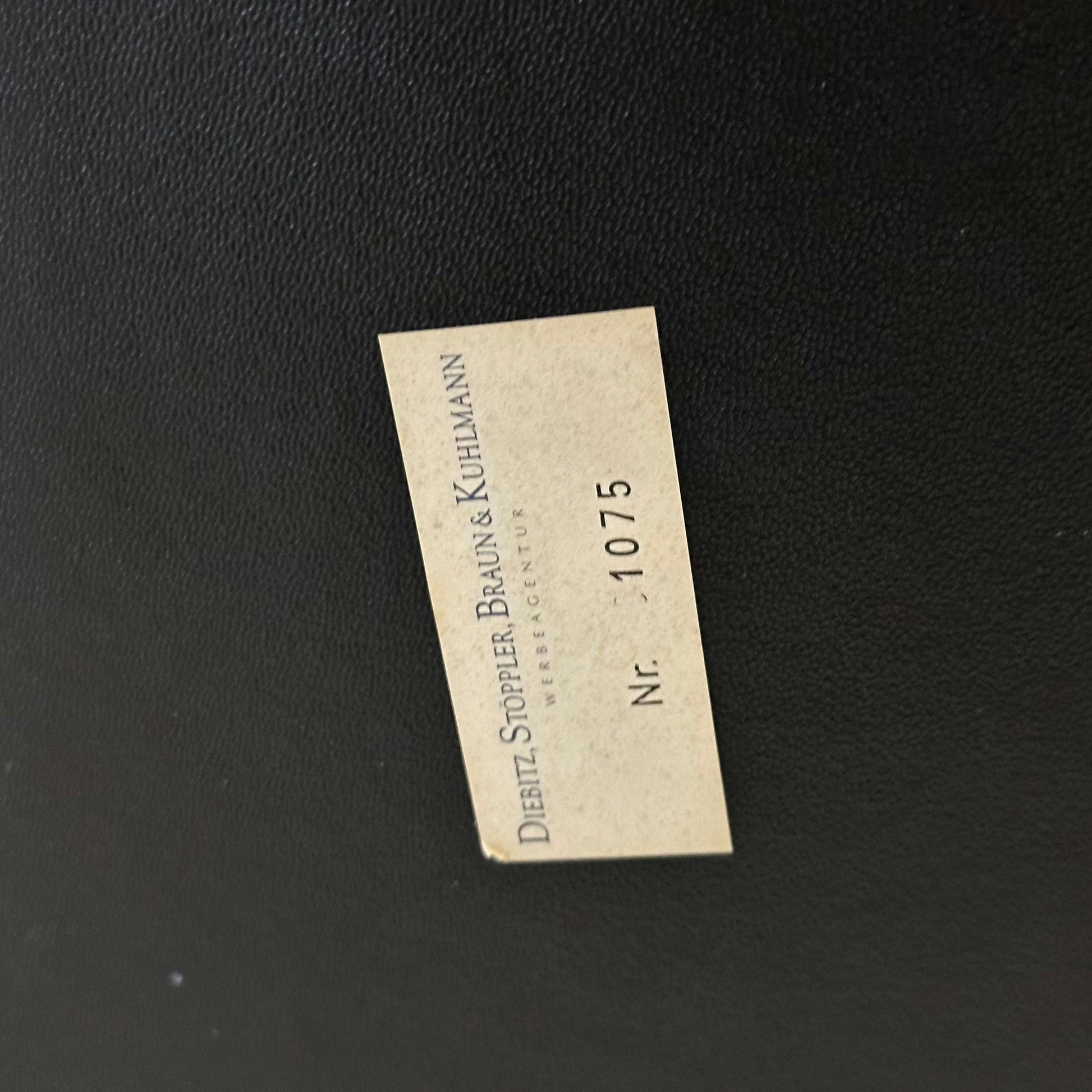 Close-up of the black leather upholstery with a Dietz Stoppler Braun & Kuhlmann label on the Wassily/Knoll Sessel replica chair.