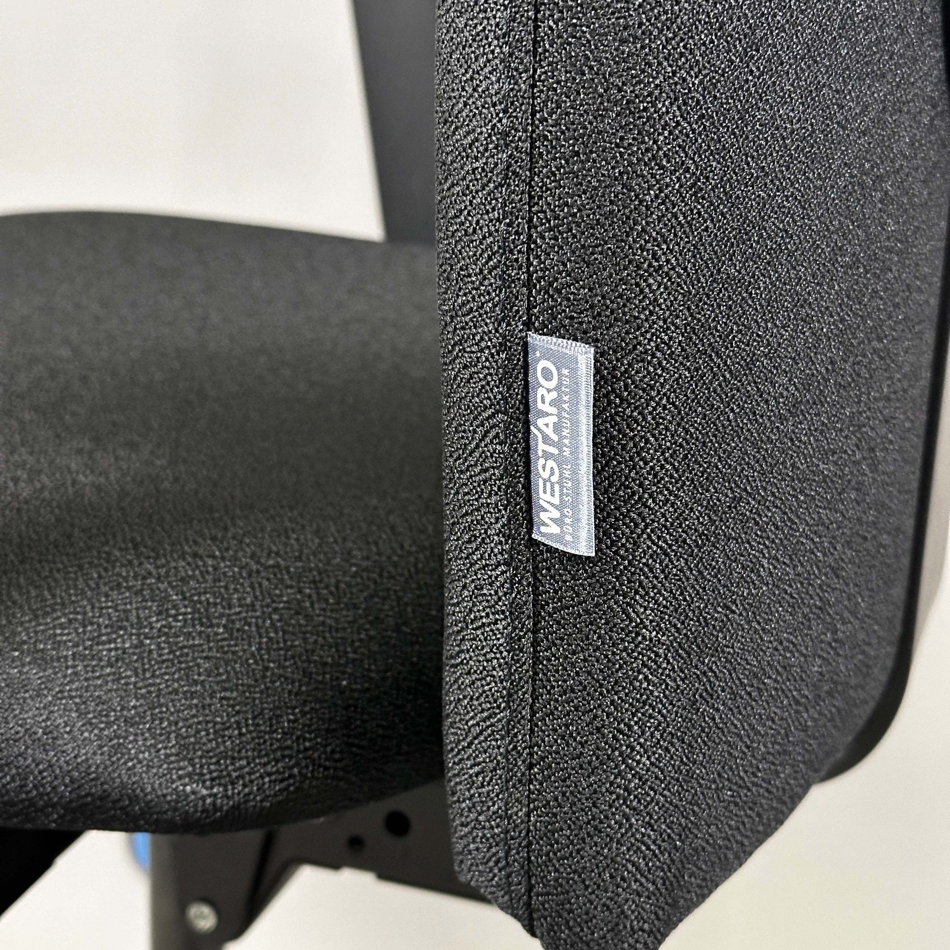 Close-up of black Westaro Enjoy ergonomic office chair fabric and label on backrest