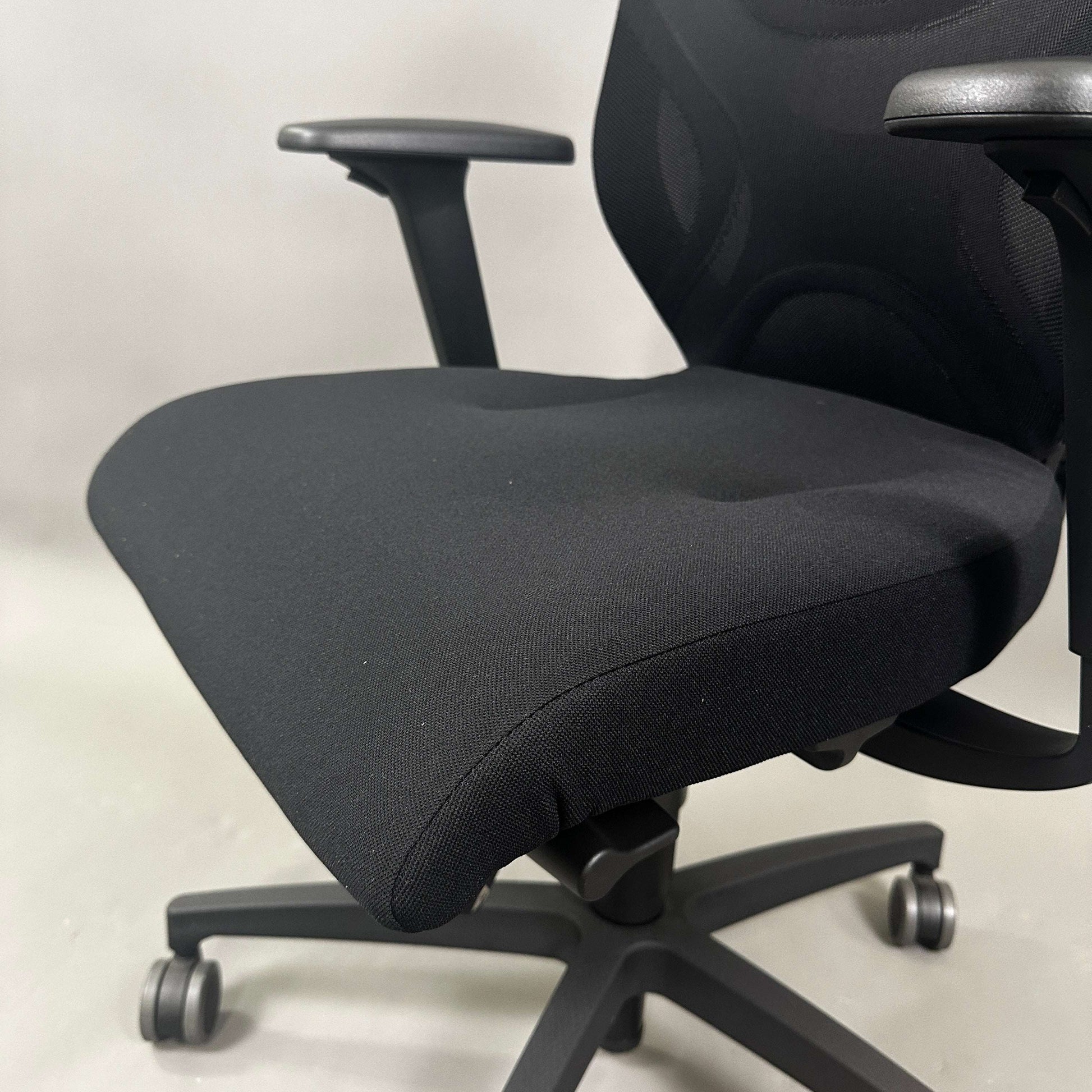 Wilkhahn IN ergonomic black office chair with adjustable height, 3D armrests, and soft casters for hard floors