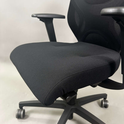 Wilkhahn IN ergonomic black office chair with adjustable height, 3D armrests, and soft casters for hard floors