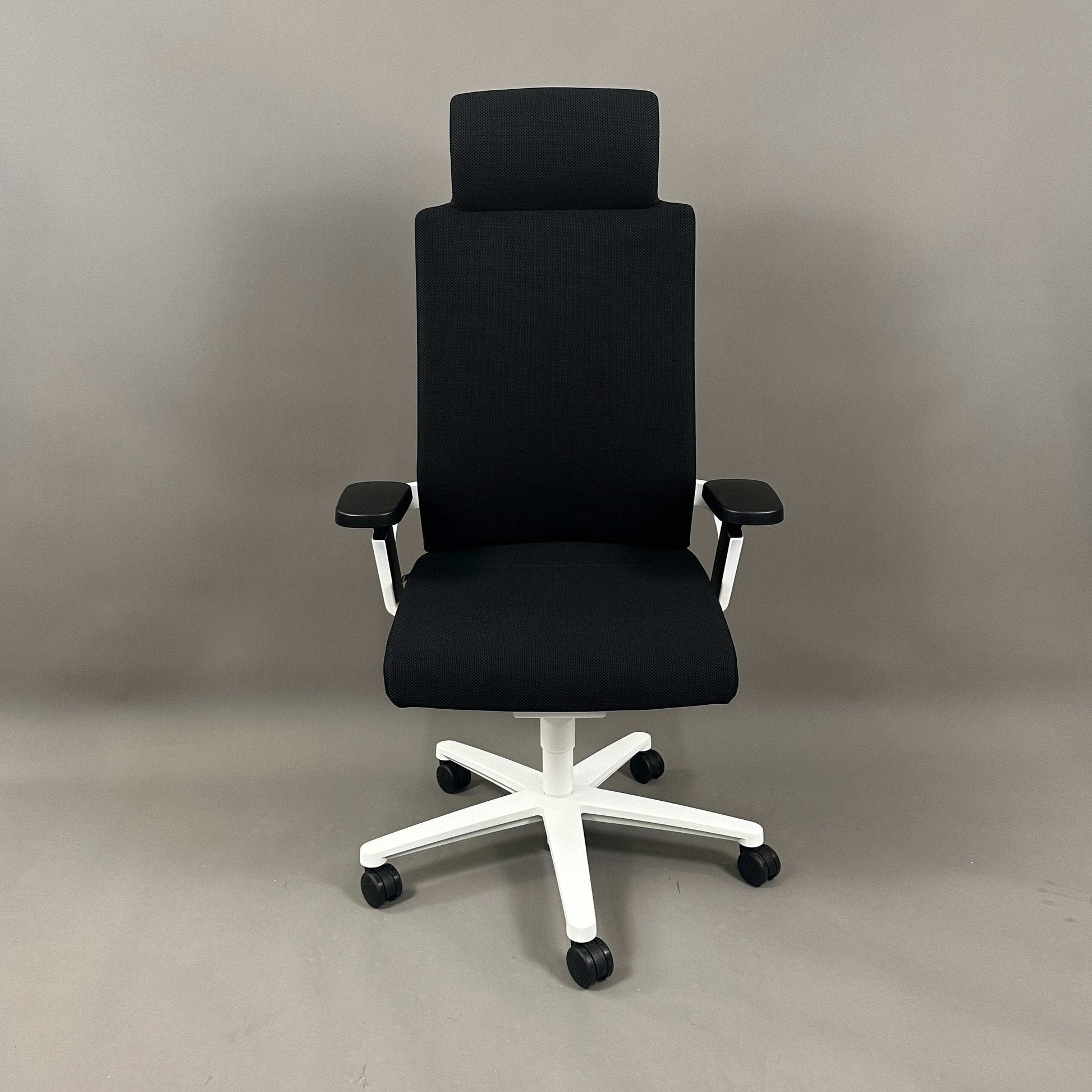 Wilkhahn ON ergonomic office chair with high back, headrest, black Fiberflex fabric, white plastic base, and adjustable armrests