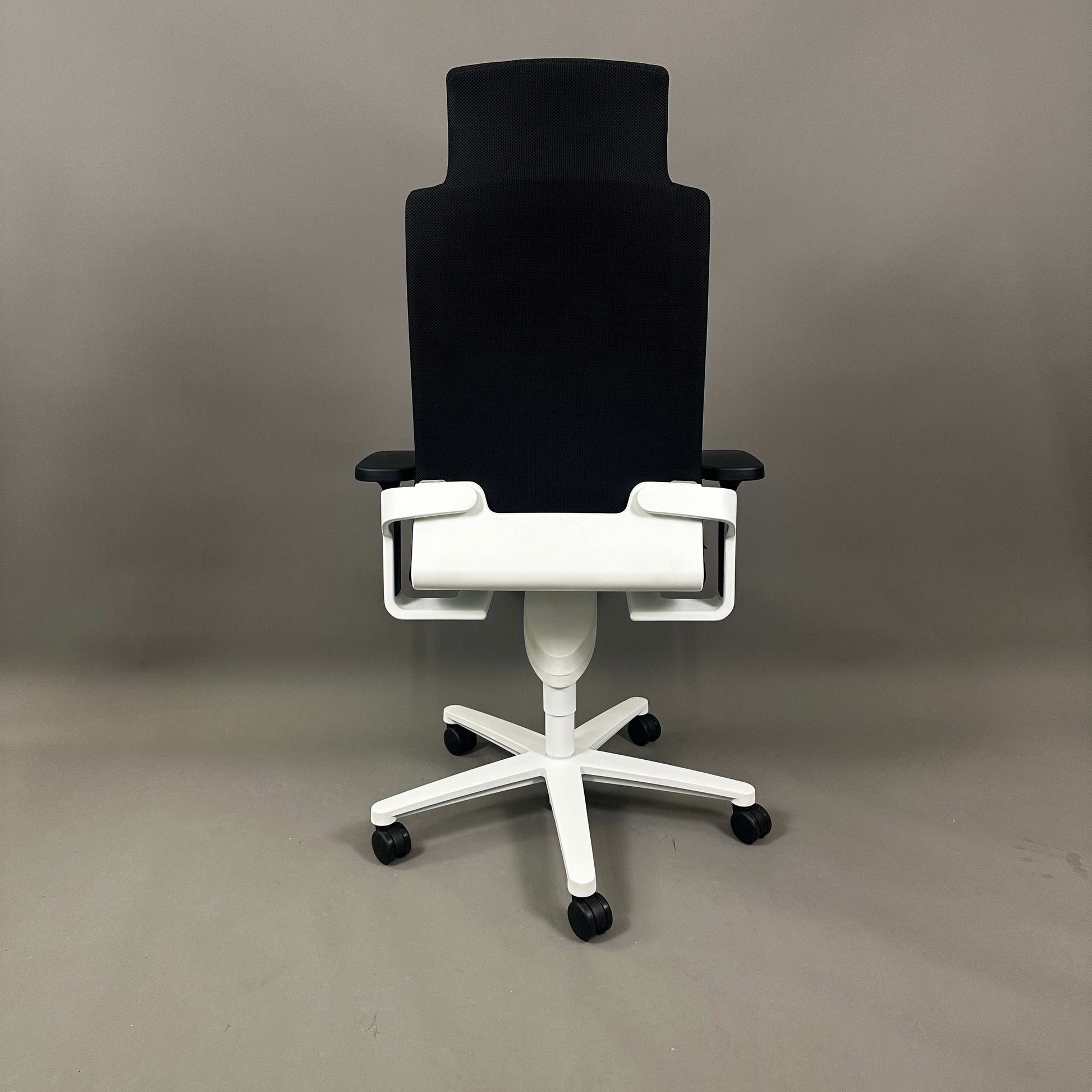 Wilkhahn ON high-back office chair with headrest, black Fiberflex upholstery, white plastic base, and universal casters.