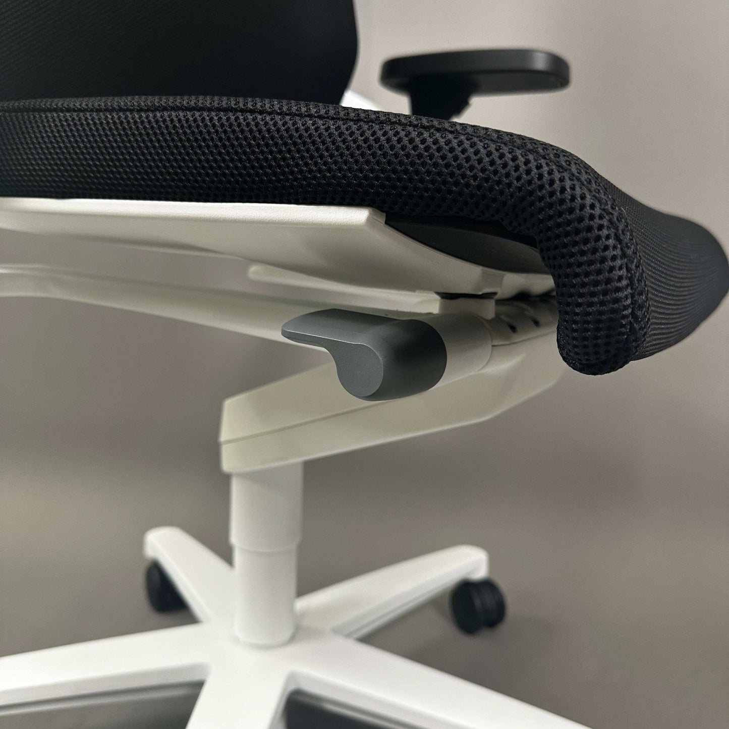 Wilkhahn ON ergonomic office chair with black Fiberflex upholstery and white plastic base with adjustable armrests and height mechanism