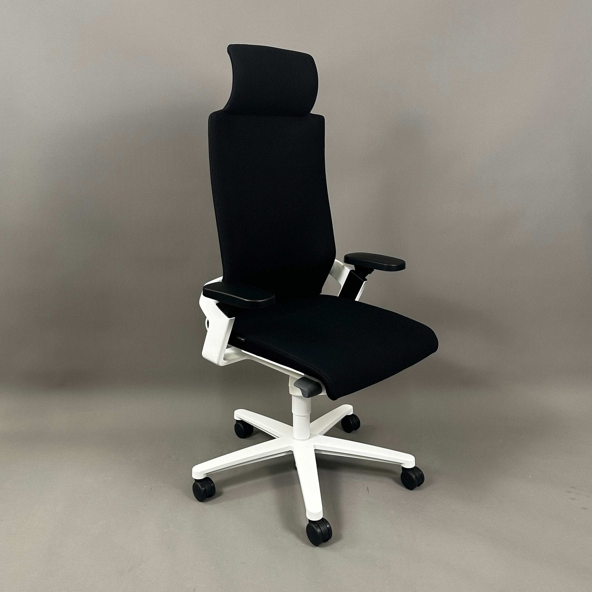 Wilkhahn ON ergonomic office chair with high back, black Fiberflex upholstery, white plastic base, adjustable headrest and armrests, universal wheels