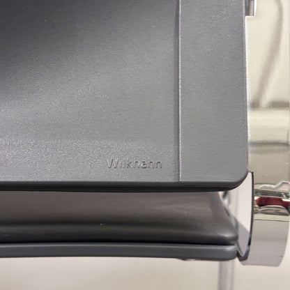 Close-up of Wilkhahn Sito black leather chair seat with chrome frame detailing