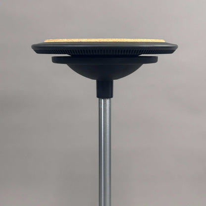 Wilkhahn Stehhilfe Stitz with cork seat cushion and adjustable height stool against gray background